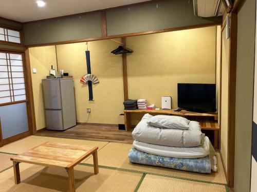 a living room with a bed and a refrigerator at SABOJI - Vacation STAY 34252v in Takamori