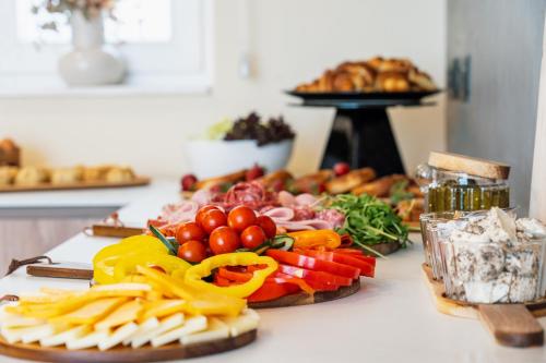 a table with a variety of fruits and vegetables on it at Stuart Rooms by Zzzing in Il-Gżira