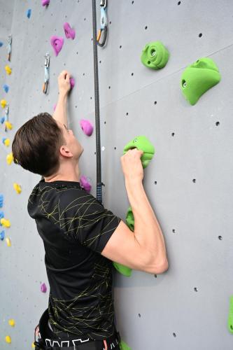 a man is climbing a rock wall at Quality Hotel Sarpsborg in Sarpsborg