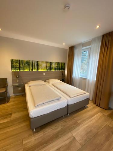 a bedroom with a large bed in a room at Hotel Scheid in Schriesheim