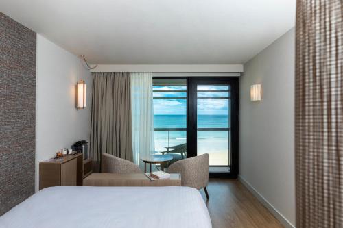 a hotel room with a bed and a view of the ocean at Oceania Saint Malo in Saint Malo