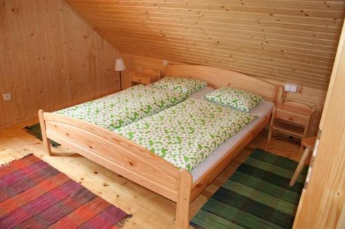 a bedroom with a wooden bed in a room at Chata Devena in Valča