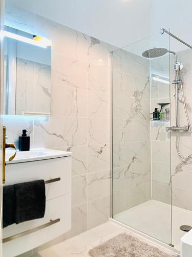 une salle de bain avec une douche avec une porte vitrée dans l'établissement Chic & Spacious Getaway in Nice - 10min to Beach, à Nice