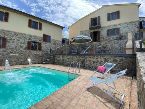 a villa with a pool and a chair and a building at Casa Montecastelli Sopra/Terra in Monte Castelli