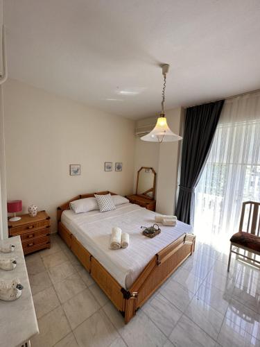 a bedroom with a large bed with towels on it at VİLLA MARMARİS in Marmaris