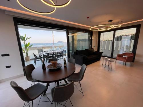 un soggiorno con tavolo, sedie e divano di Poseidon Beach Hotel a Laganas