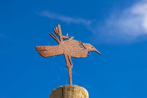 a wooden sign on top of a piece of wood at Kūkupa Puni at Akaroa Lavender by Tiny Away in Akaroa