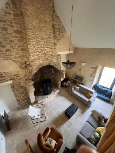 an overhead view of a living room with a stone fireplace at La grange - Grande longère à moins de 30 minutes des plages in Plumelec