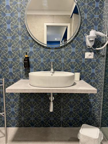 a bathroom with a sink and a mirror at Black Room & Breakfast in Bari