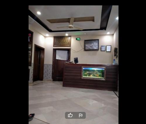 a lobby with a fish tank on a counter at Garden View Hotel in Lahore