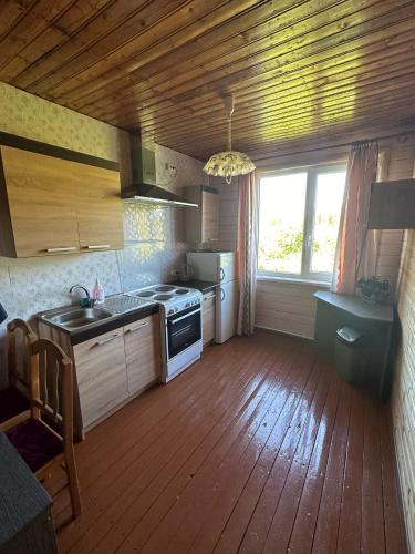 a kitchen with a stove and a window in it at Ķīšupe in Saulkrasti