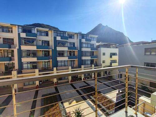a view of a building with mountains in the background at Beach Loft in Muizenberg