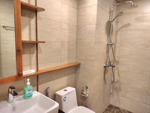 a bathroom with a shower and a toilet and a sink at Tony Apartment -FLC Sea Tower Quy Nhon in Quy Nhon