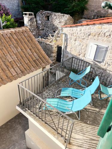 a group of chairs sitting on a balcony at Villa San Marco in Hvar