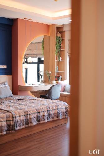 a bedroom with a bed and a desk and a mirror at Tony Apartment -FLC Sea Tower Quy Nhon in Quy Nhon