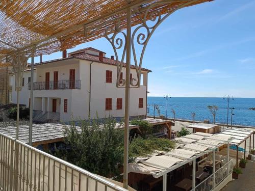 a building on the beach with the ocean in the background at Ristorante Paisà. Cibo e Ospitalità in Agnone