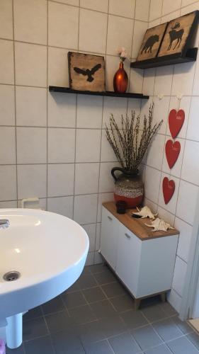 a bathroom with a white tub and a sink at Diba beach stay in Kolding