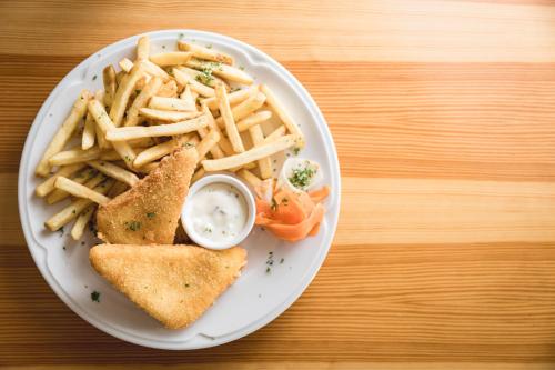 a plate of food with french fries and a sandwich at Apartmány Vilka Orlík in Teplice nad Metují