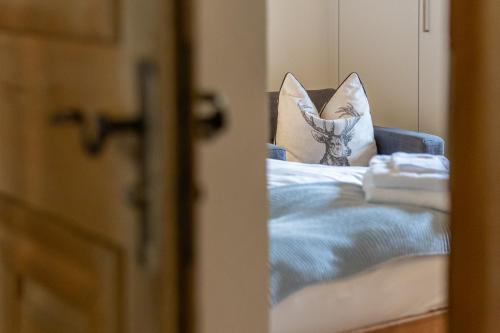 a room with a bed with a pillow on it at Chesa-Strimer - Studio in La Punt-Chamues-ch