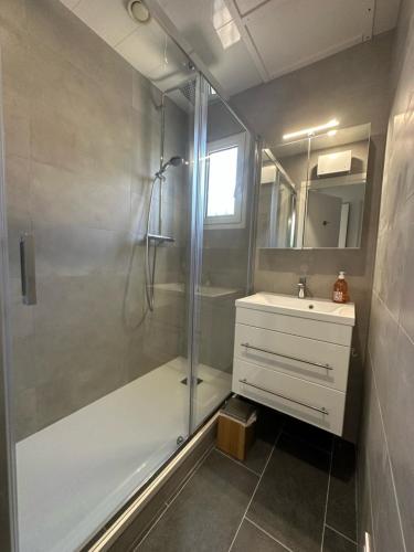 une salle de bain avec une douche, une baignoire et un lavabo dans l'établissement Village naturiste - Port-Vénus - Villa les pieds dans l'eau, au Cap d'Agde