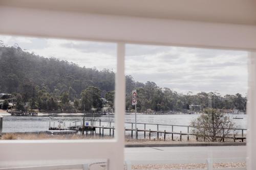 a view of a lake from a window at Riverside Retreat in Orford in Orford