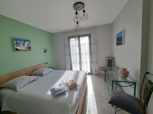 a bedroom with a bed with white sheets and a window at Havre de paix en Drôme villa moderne climatisée - jacuzzi "la maison d'à côté" in Chatuzange-le-Goubet