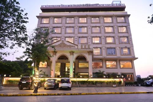 a building with cars parked in front of it at The Fern Residency Sarnath in Varanasi