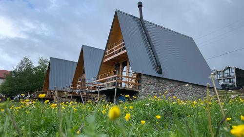 a house with metal panels on the side of it at AURA Cottages in Stepantsminda
