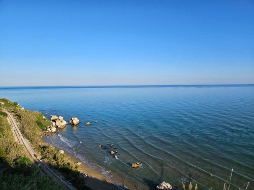 a group of people in the water at a beach at Joivy Dimore Rodiane - U Vucc'l in Rodi Garganico