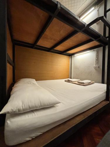 a bunk bed with two pillows on top of it at Hansa Hostel Bangkok Khaosan in Bangkok
