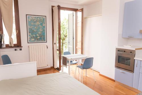 a room with a bed and a table and chairs at Casa Alura in Bergamo