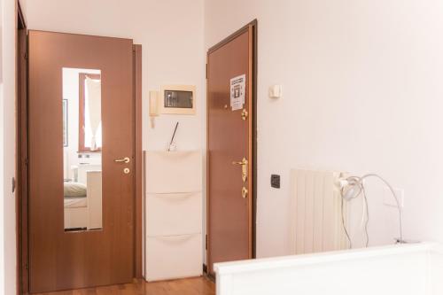 a large mirror in a room with a door at Casa Alura in Bergamo