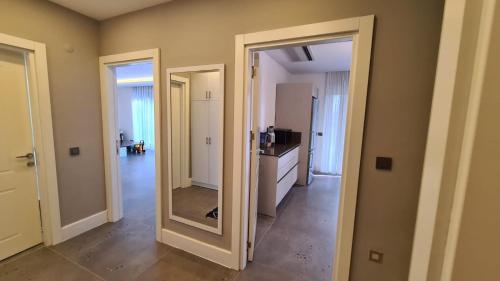 a hallway with two doors and a mirror at Уютная вилла в Чамьюва in Kemer
