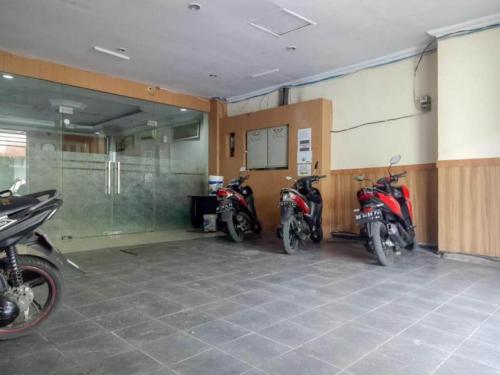 a group of motorcycles parked in a garage at RedDoorz near Balai Kota Makassar in Makassar