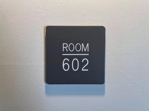 a clock on a wall with the word room at Hotel Yuzuki in Takamatsu