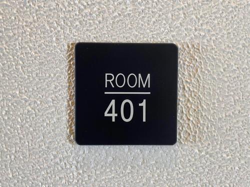 a black button with the words room on a white wall at Hotel Yuzuki in Takamatsu