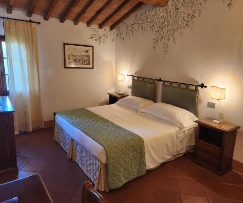 a bedroom with a large bed in a room at Villa Curina Resort in Castelnuovo Berardenga