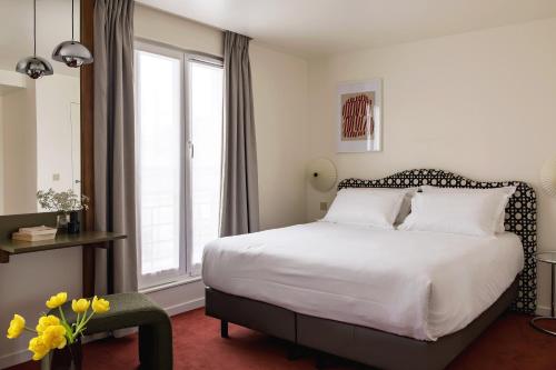 Voodi või voodid majutusasutuse Hôtel Dalila toas