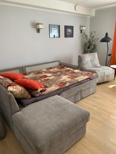 a bed sitting on top of a couch in a living room at Karusselli 66a in Pärnu
