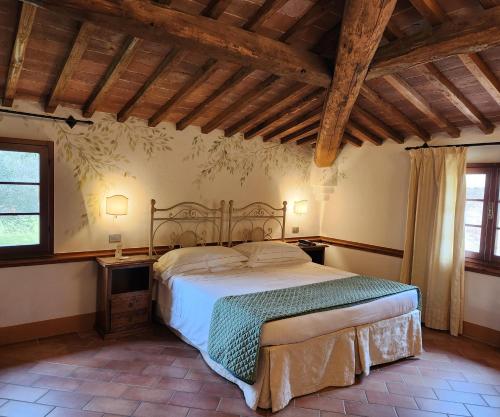 a bedroom with a large bed in a room at Villa Curina Resort in Castelnuovo Berardenga