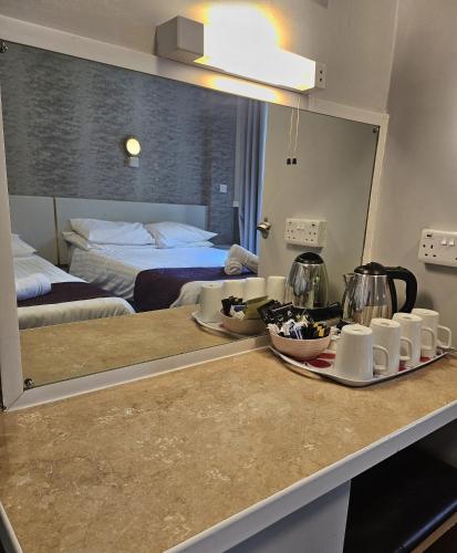 a kitchen counter with a mirror in a hotel room at The Blenheim Mount Hotel in Blackpool