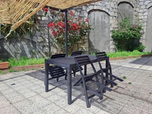 a wooden table with two chairs and an umbrella at Spacious Apartment in Sori with Large Terrace in Sori