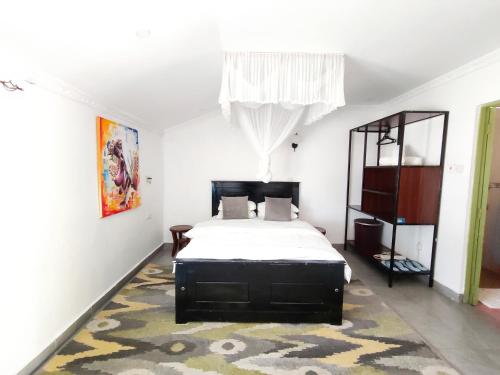 a bedroom with a bed and a rug at MILIMANI DRIVE LIVINGs in Kisumu