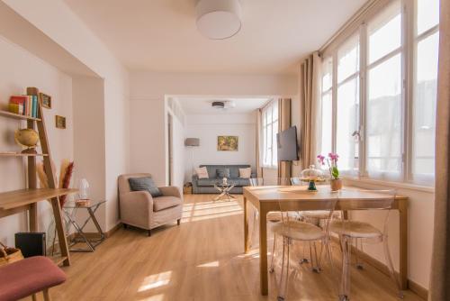 un salon avec une table, des chaises et un canapé dans l'établissement Luxury Art Deco Elegant Escape by Eiffel Tower, à Paris