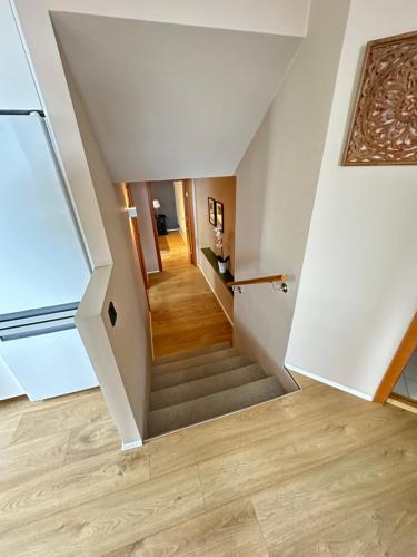 a staircase in a house with wooden floors at Apartment in Huldubraut in Kópavogur - Birta Rentals in Reykjavík