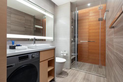 a bathroom with a sink and a toilet and a shower at Fraser Place Wujiaochang Shanghai - Adjoin business center, free minibar in Shanghai