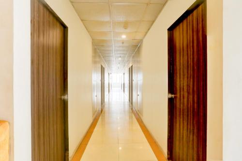 a corridor of an office building with two doors at FabHotel Prime Ace II - Near Jupiter Hospital in Vadodara