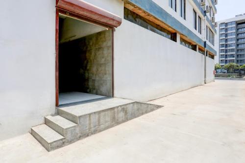 a building with stairs leading into a garage at FabHotel Prime Ace II - Near Jupiter Hospital in Vadodara