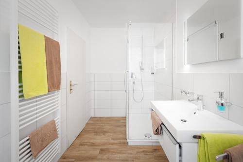 a white bathroom with a sink and a shower at Zur Alten Post in Nottuln