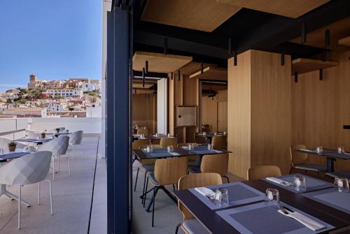 a restaurant with tables and chairs with a view at Core Ibiza Town Hotel in Ibiza Town